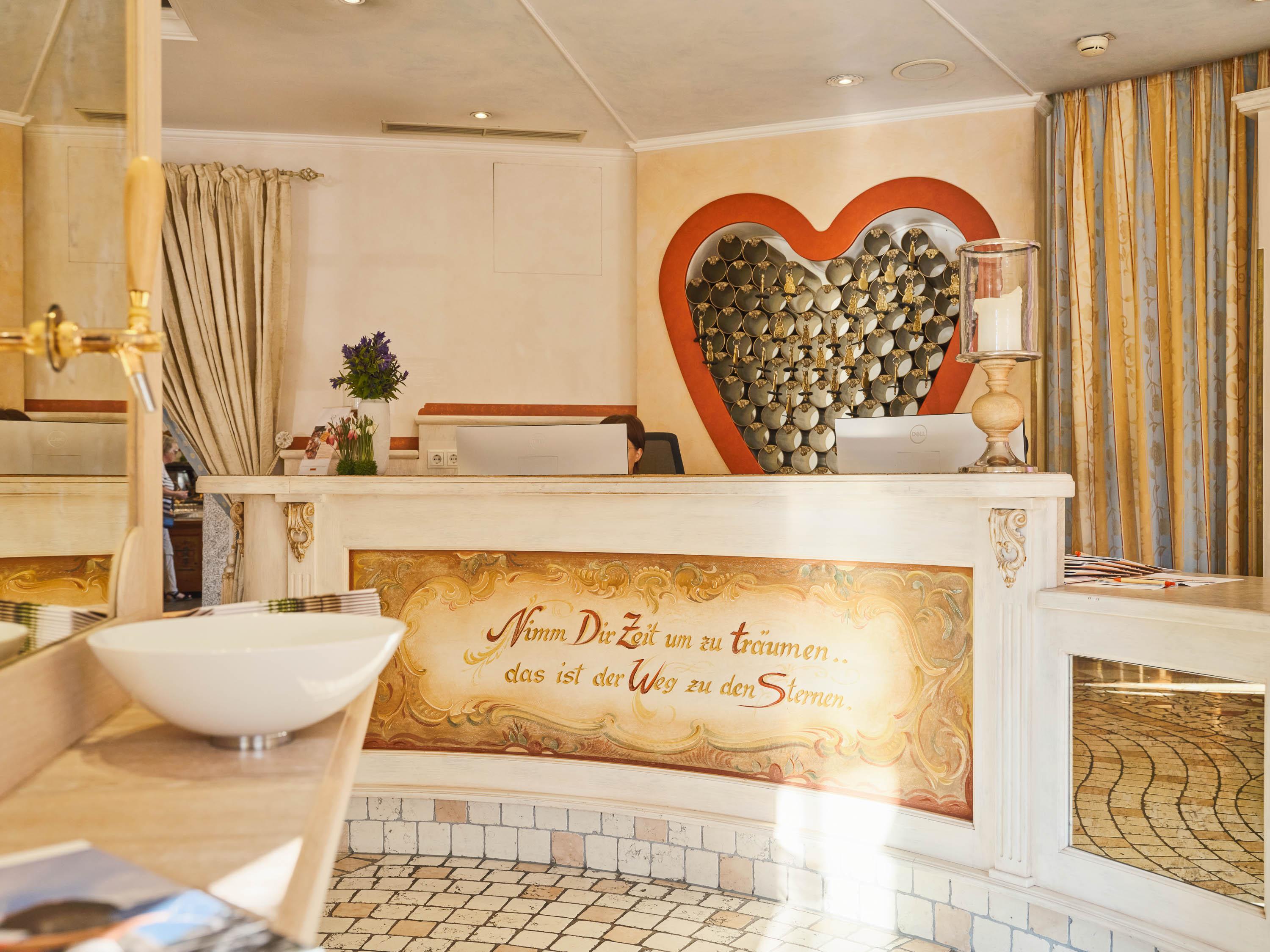 An inviting reception area with a heart-shaped decor. Soft colors and a cozy atmosphere create a relaxing environment.