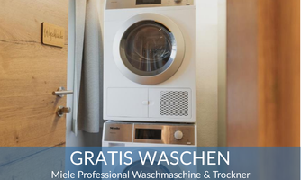 A Miele washing machine and a dryer stand side by side in a room. The text informs about free washing.