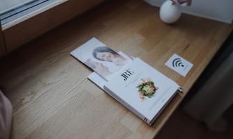 A wooden shelf with an open magazine and a small vase. Next to the magazine lies a WiFi symbol.