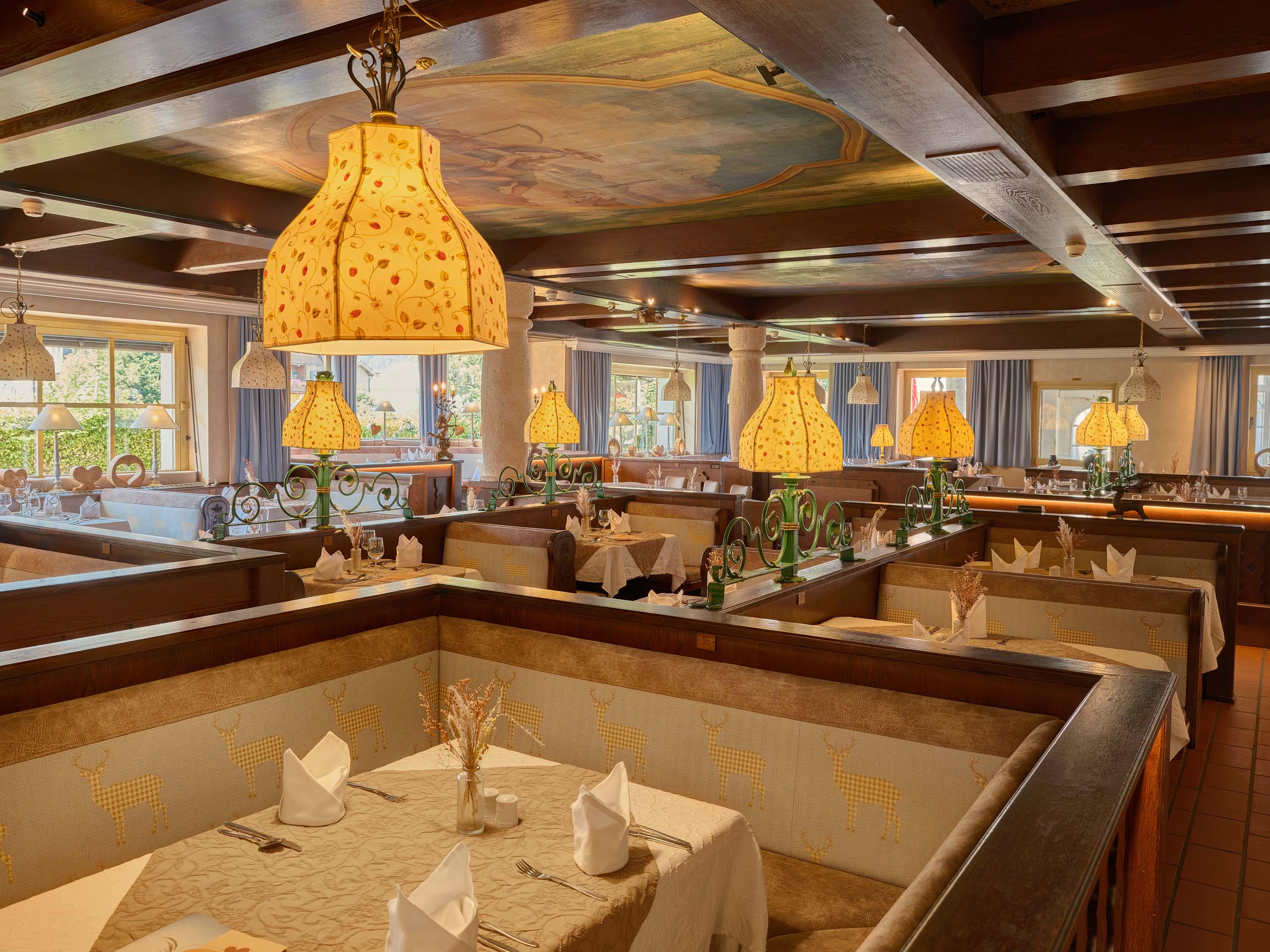 An inviting restaurant with cozy tables and warm lighting. The decor is elegant and creates a pleasant atmosphere.