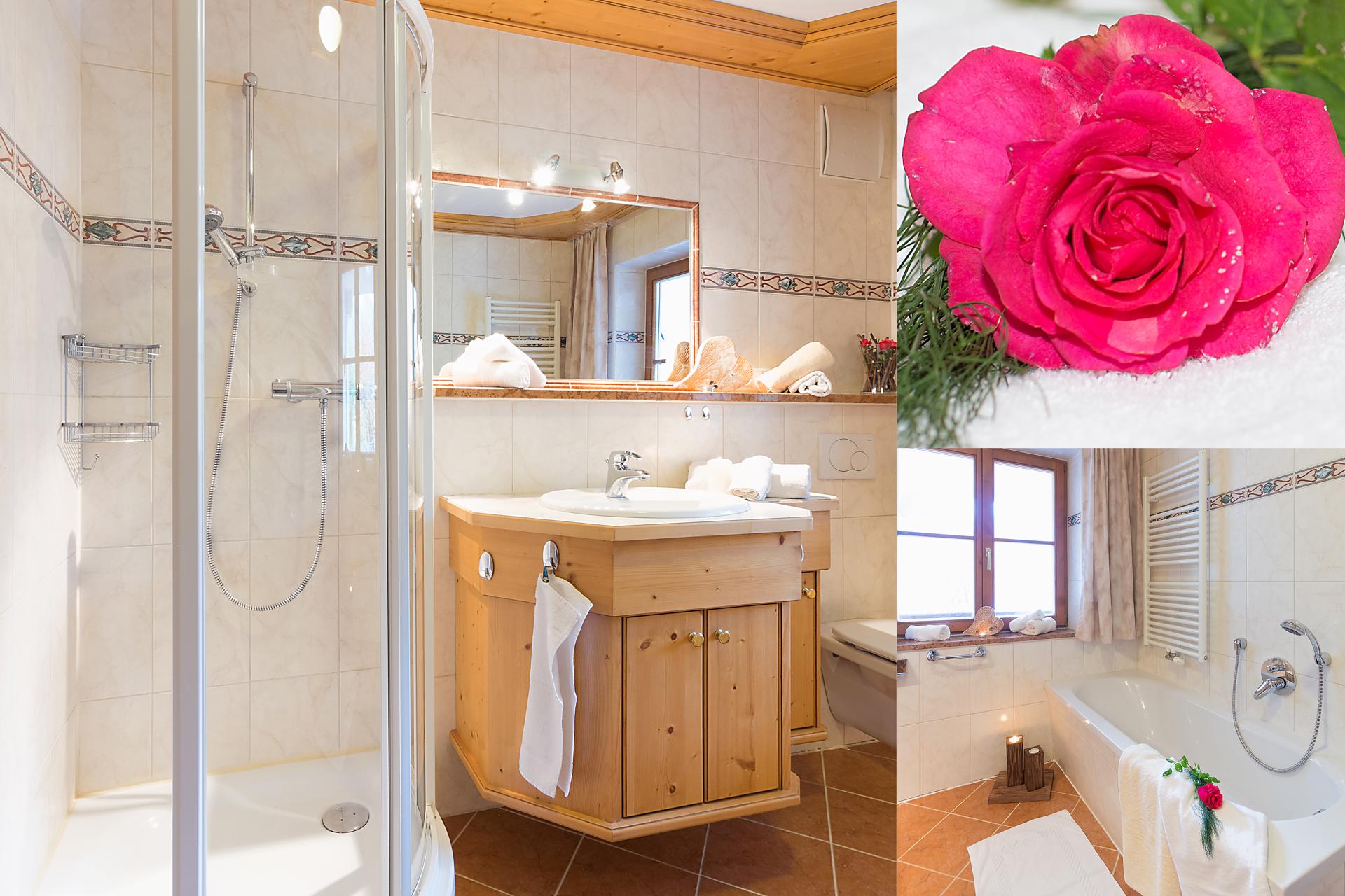 A modern bathroom with a shower and a bathtub. On the right side lies a pink rose that complements the ambiance.