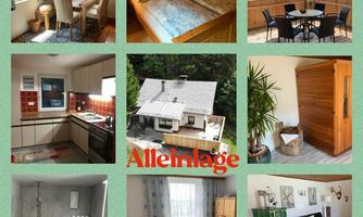 A cozy holiday home with various rooms, including a bedroom, a fully equipped kitchen, and a modern shower. The outdoor area features a table with chairs and a beautiful view of nature.