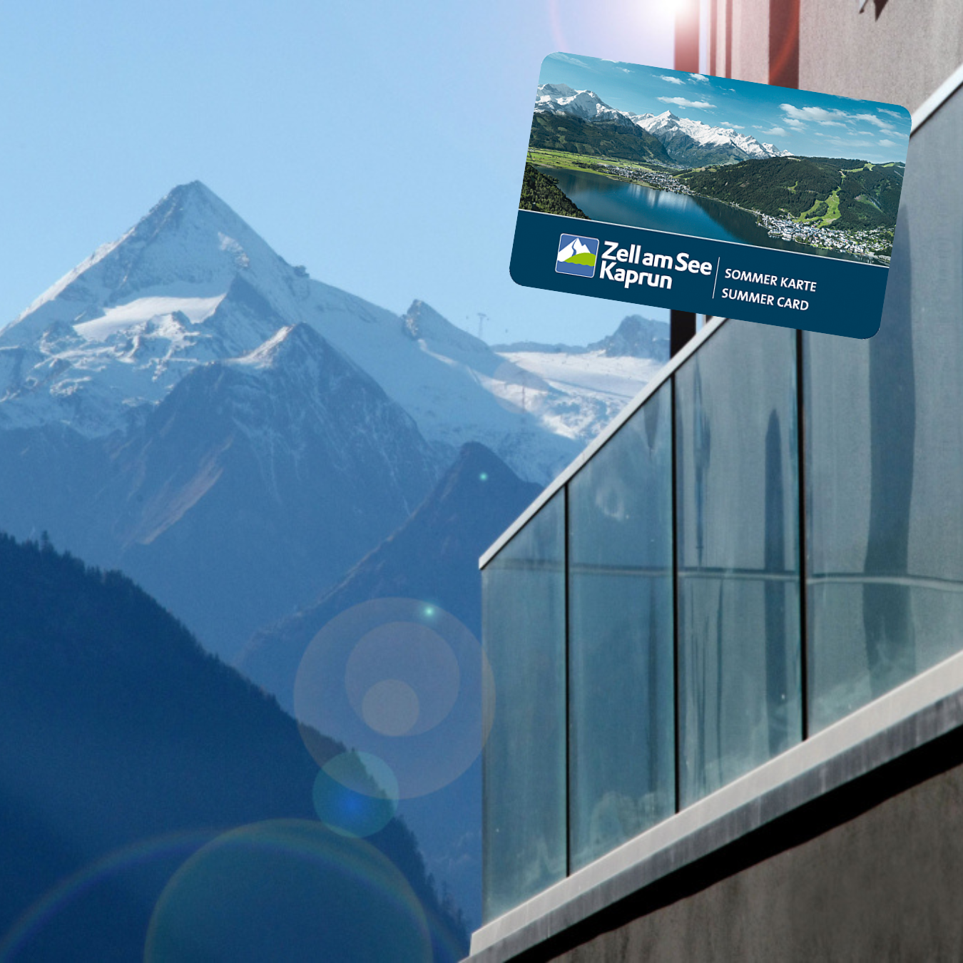 A clear view of majestic mountains with a sunlight reflection. In the foreground, there is a summer map of Zell am See-Kaprun.