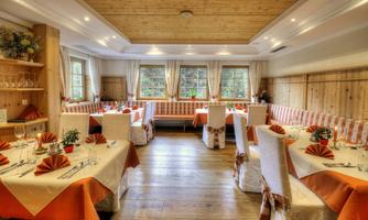 An inviting restaurant with wood decor and warm colors. The tables are elegantly set and provide seating for guests.