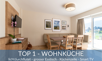 A bright living space with a large dining table and a modern kitchenette. The terrace is clearly visible through large windows.