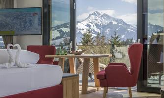 An elegant room with a great view of snow-covered mountains. Large windows let in plenty of light and create a cozy atmosphere.