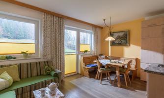 A cozy living kitchen with dining area and lounge corner