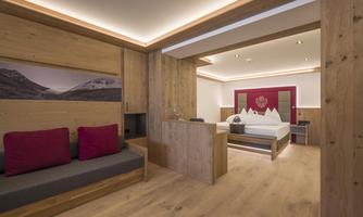 A modern room with wooden walls and a double bed. The decor is simple and cozy, perfect for a relaxing stay.