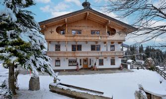 A charming, rustic building in a snow-covered setting. The facade displays traditional alpine architecture and a welcoming atmosphere.