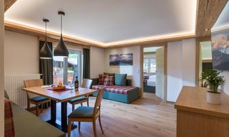A bright and modern living kitchen with wooden floors and elegant furniture. The room is tastefully decorated and offers plenty of space to relax.