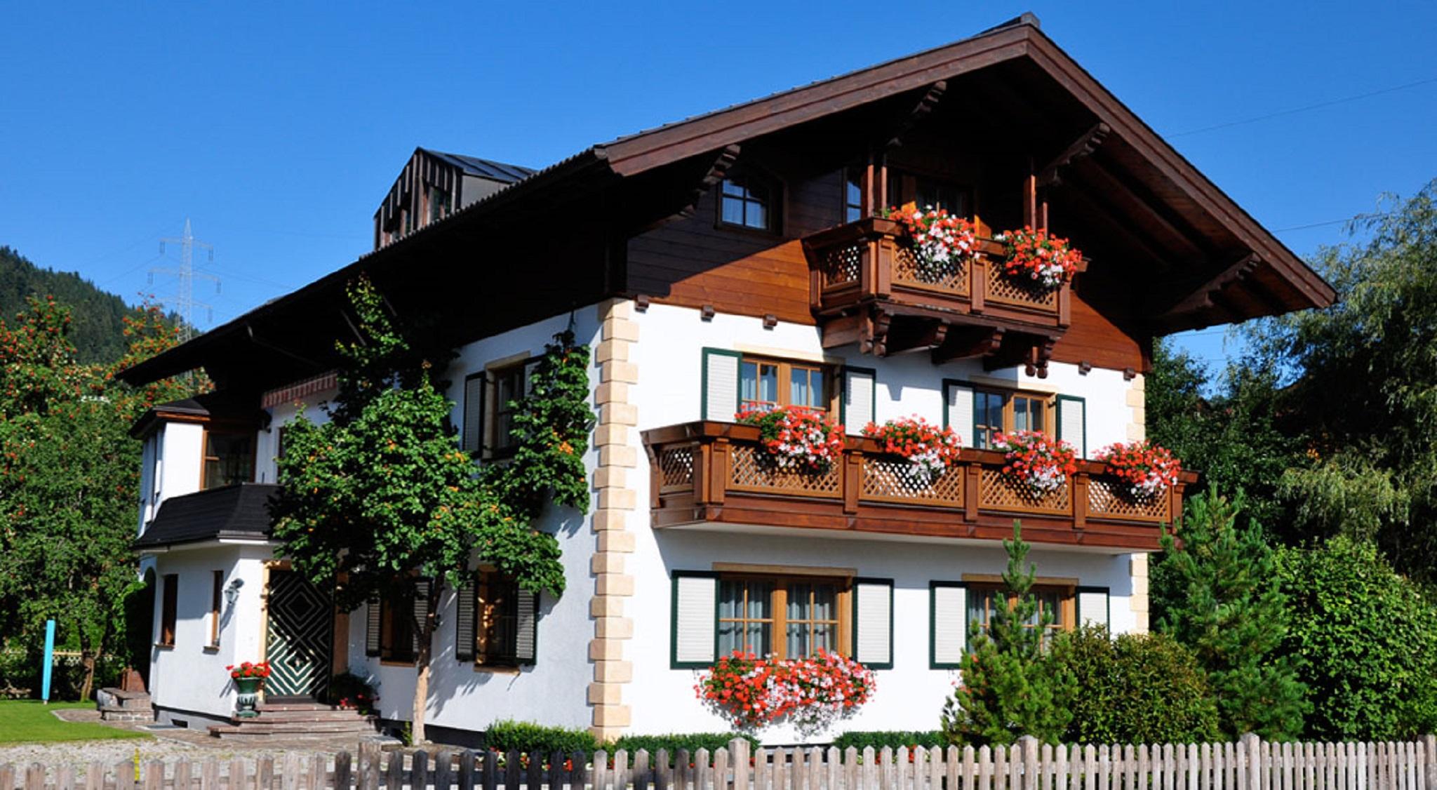 A beautiful traditional house with flowers on the balcony and comfortably furnished apartments for guests.