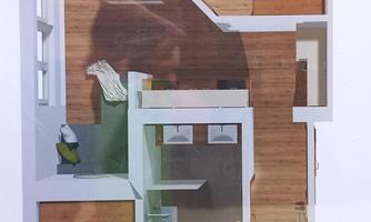 A modern apartment with two bedrooms and an open living area. The floor is made of wood and large windows provide plenty of light.