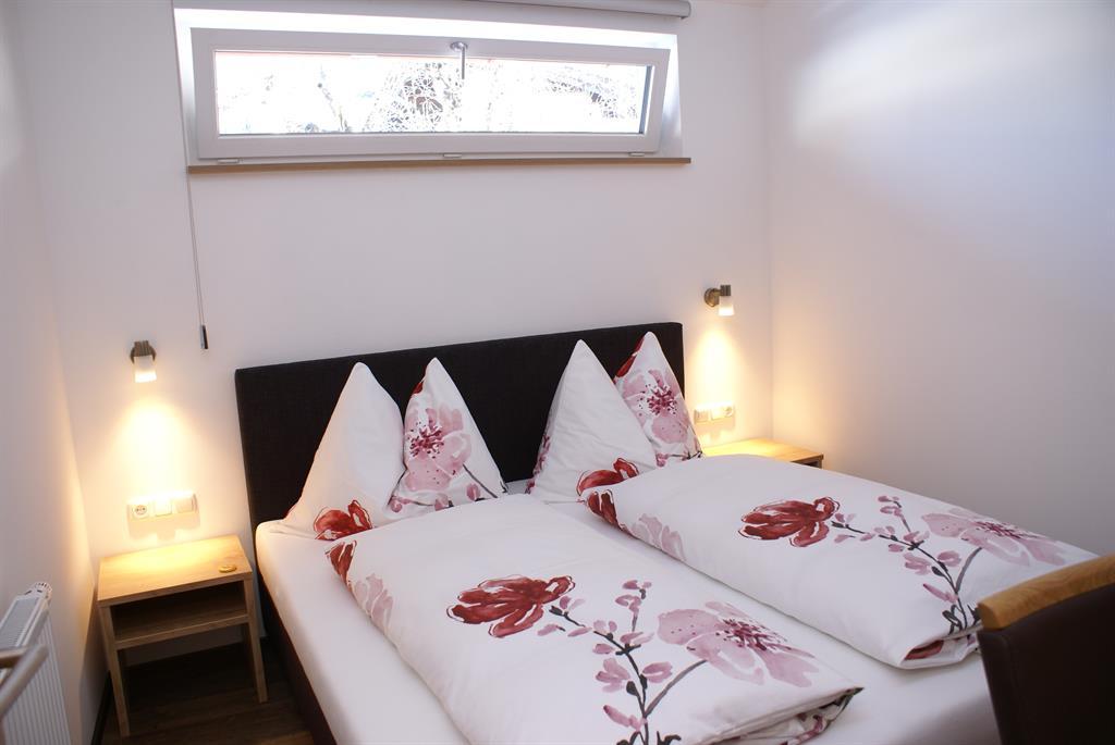 A cozy bedroom with a box spring bed.