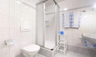 A modern bathroom with a shower and toilet. Towels are provided for the holiday.