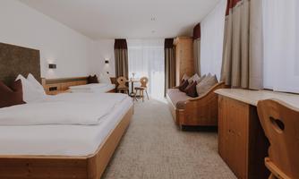 A bright Family Room with a double bed, a single bed, and a cosy sofa bed.