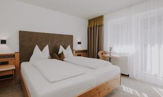 A modern Double Room Comfort with a double bed and spacious design.