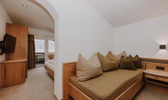 A cosy room with wood paneling and a large window.