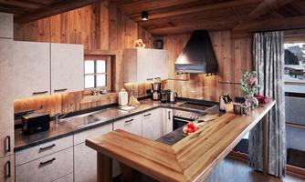 Fully equipped chalet kitchen with reclaimed wood and modern technology. The open kitchen combines rustic alpine hut charm with high-quality equipment. Fronts in natural stone look, a solid wood bar, and wall paneling made of reclaimed wood create a warm, inviting atmosphere. Equipped with a ceramic cooktop, oven, coffee machine, toaster, and other amenities, this kitchen leaves nothing to be desired. The cozy breakfast bar with panoramic views invites you to enjoy and linger – perfect for shared cooking moments in the heart of the chalet.