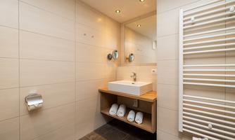 A modern bathroom with a vanity. Towels are provided for the holiday.