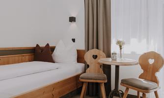 A cosy Family Room with a double bed, a single bed, and a sofa bed with bright pillows.
