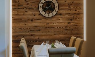 A stylish restaurant with a wooden shelf and elegant table decoration.