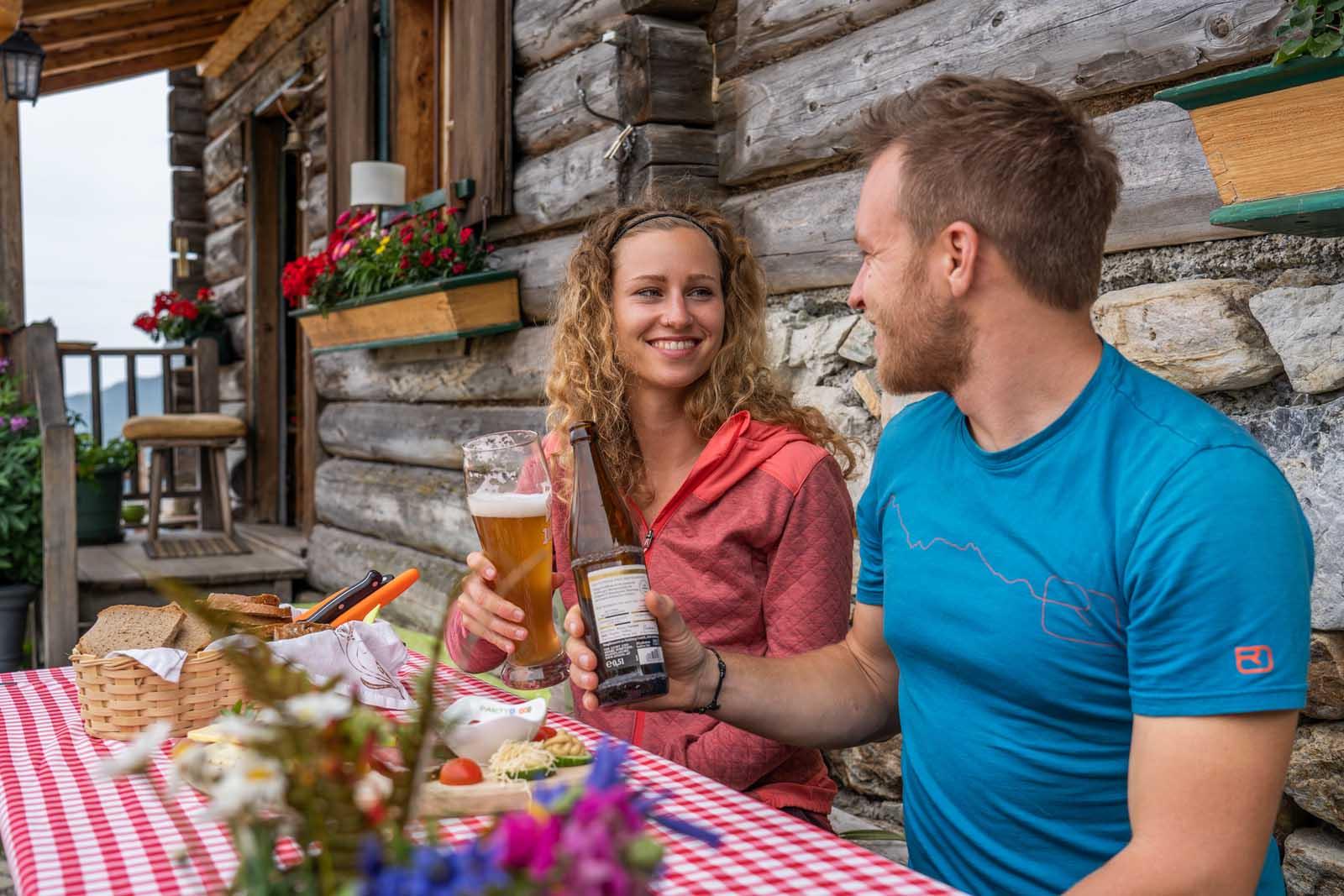 Cozy, traditional snack in a mountain hut with bacon bread and cool drinks