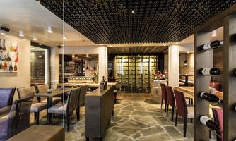 A modern restaurant with an elegant wine cellar view. The interior is stylishly decorated and offers a pleasant atmosphere.