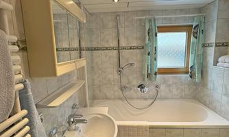 A bathroom with a sink, a bathtub, and a toilet.