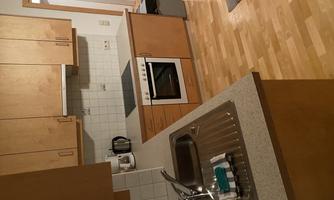 A modern kitchen with wooden cabinets and a bright floor. It is well equipped with a stove, a sink, and some electrical appliances.