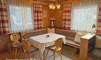 A cozy dining area in a pine room.