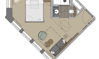 A floor plan of a room with a bed, a bathroom, and a seating area. The furniture is arranged simply and functionally.