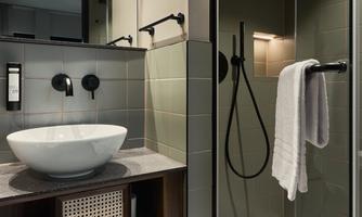 A modern bathroom with an elegant shower and a stylish sink. The neutral colors create a relaxed atmosphere.