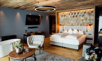 A modern hotel room with a cozy bed and elegant furnishings. The atmosphere is warm and inviting, perfect for relaxing.