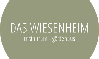 A round logo with a simple design. The text reads "Das Wiesenheim - Restaurant - Gästehaus".