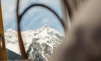A beautiful view of snow-covered mountains. The sky is clear and blue.